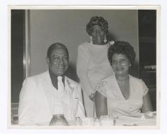 Three guests at a formal dinner