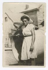 Palm Solistine Briscoe standing at the bottom of emergency chute at original Garnet High School 