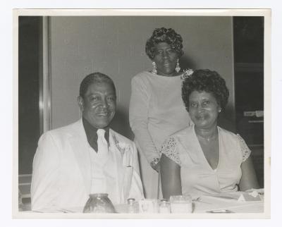 Three guests at a formal dinner