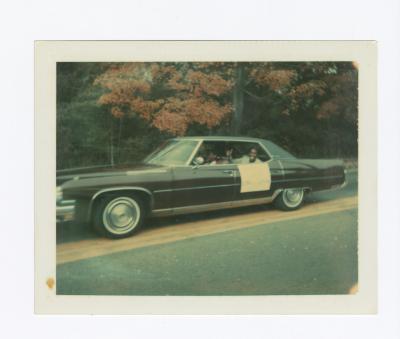 Holding a sign out the car window