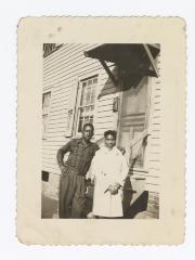 Two people standing before a door