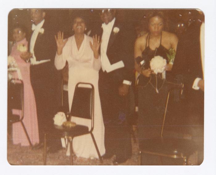 Palm Solistine and Oliver Briscoe stand behind daughter Kim's debutante chair at cotillion Ball