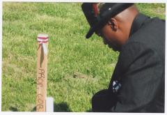 Bishop Ronald T. Fisher with wooden stake
