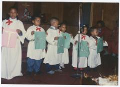 Children with signs at the Gospel Church of God