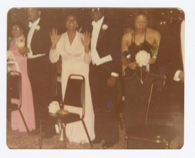 Palm Solistine and Oliver Briscoe stand behind daughter Kim's debutante chair at cotillion Ball