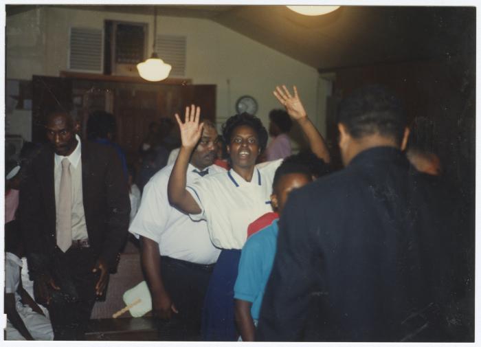 Woman with raised hands at the Gospel Church of God