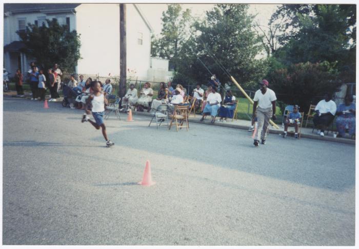 Young boy running on Calvert Street