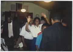 Woman with raised hands at the Gospel Church of God