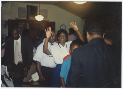 Woman with raised hands at the Gospel Church of God
