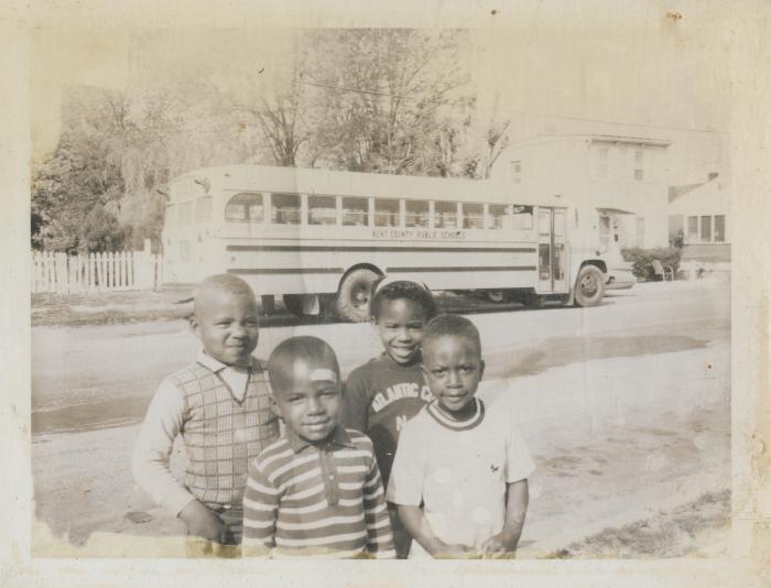 Four children in front of Aunt Minnie's Day Care