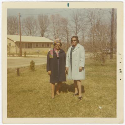 Helen Hamilton and sister Lauretta H. Dotson standing in front of Helen's house