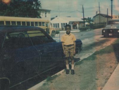A young boy near school buses