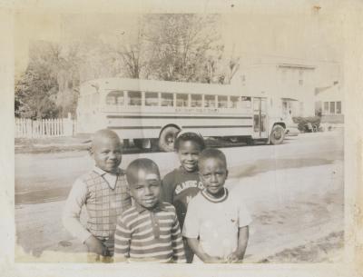 Four children in front of Aunt Minnie's Day Care