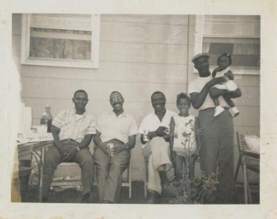 Group of people at a family reunion in the backyard of a Washington Park house