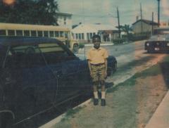 A young boy near school buses
