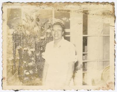A woman in front of a Christmas tree