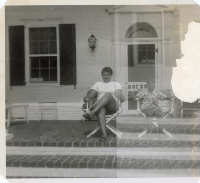 Woman and young boy sitting on a porch