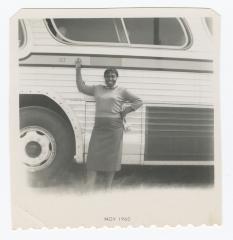 Friend of Sylvia Sparks posing in front of bus