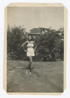 Woman posing in front of bushes