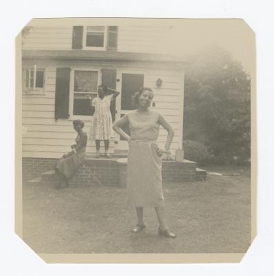 Three women in front of a house