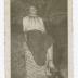 Betty Wilson sitting on brick pillar