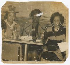 Three women seated at the Uptown Club