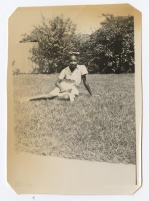 Young girl sitting in the grass