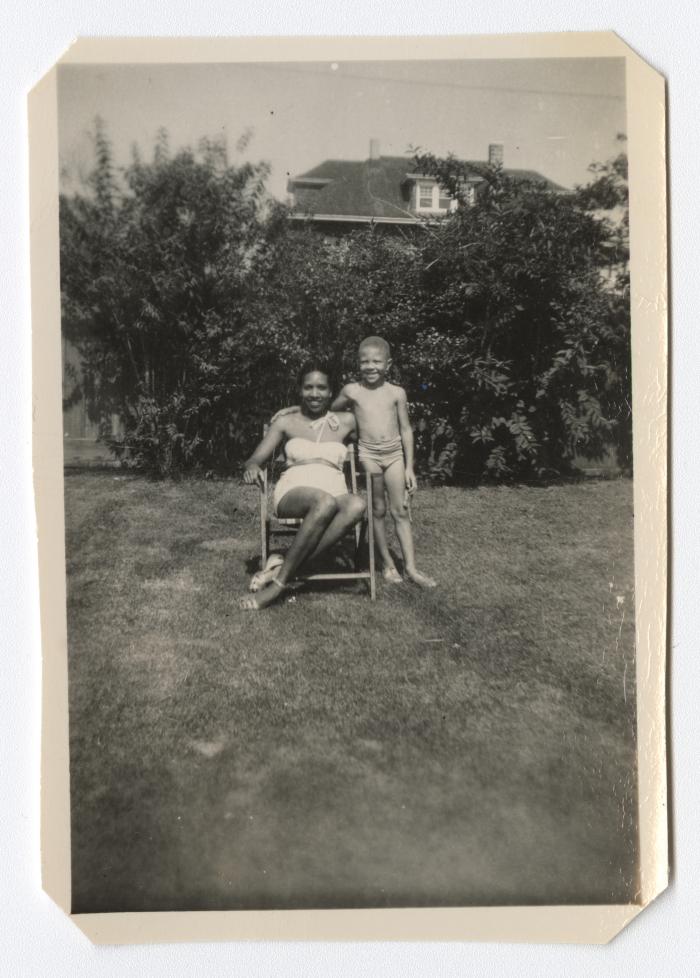 Woman and young boy posing in the backyard