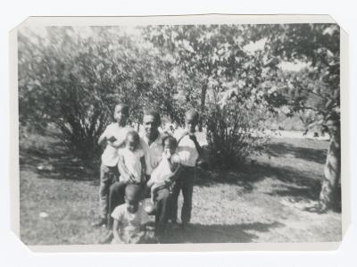 Man posing with five children