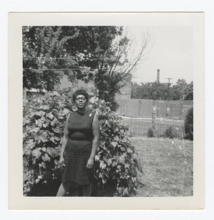 Pearl Cann standing in front of a bush