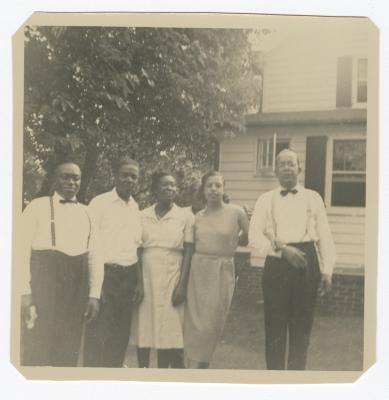 Five adults standing outside