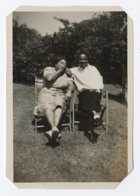 Man and woman sitting outdoors in chairs