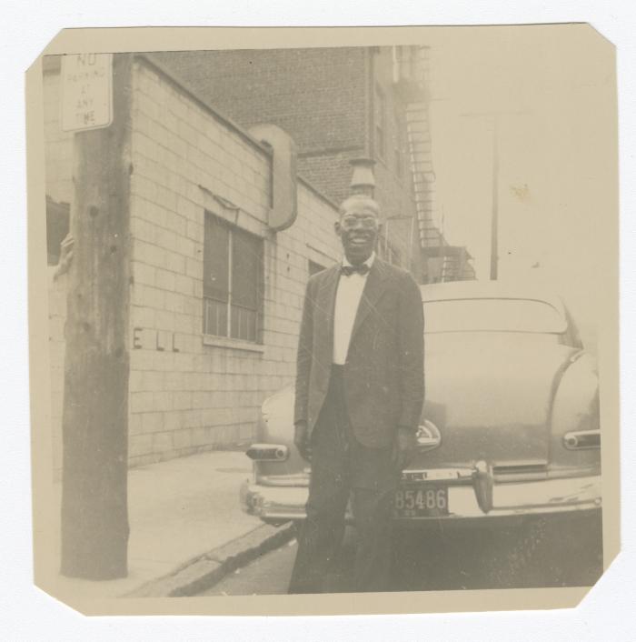Man standing behind a car