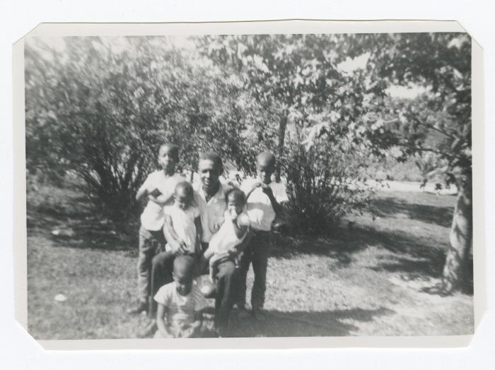 Man posing with five children