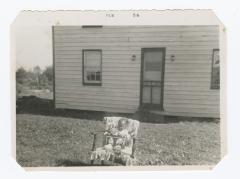 Kenneth Sparks Jr. in a lawn chair in front of family home
