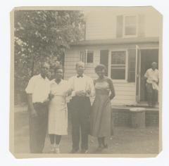Group of four posing outside