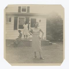 Three women in front of a house