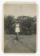 Woman posing in front of bushes