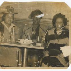 Three women seated at the Uptown Club