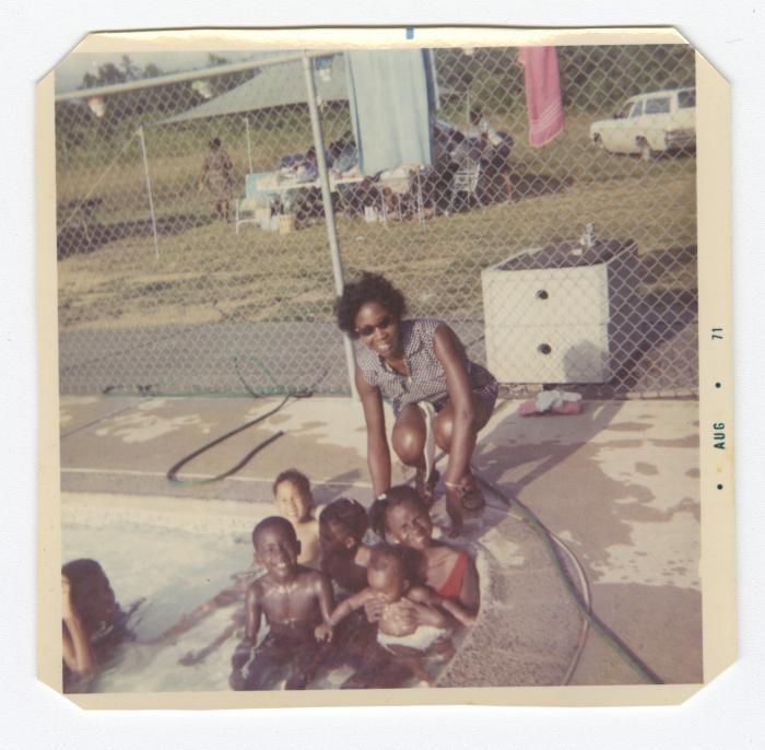 Sylvia May and children in a swimming pool