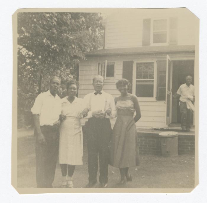 Group of four posing outside