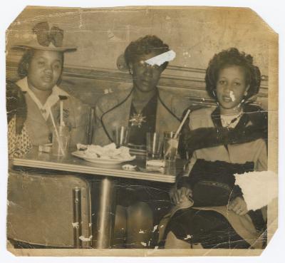 Three women seated at the Uptown Club