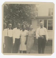 Five adults standing outside