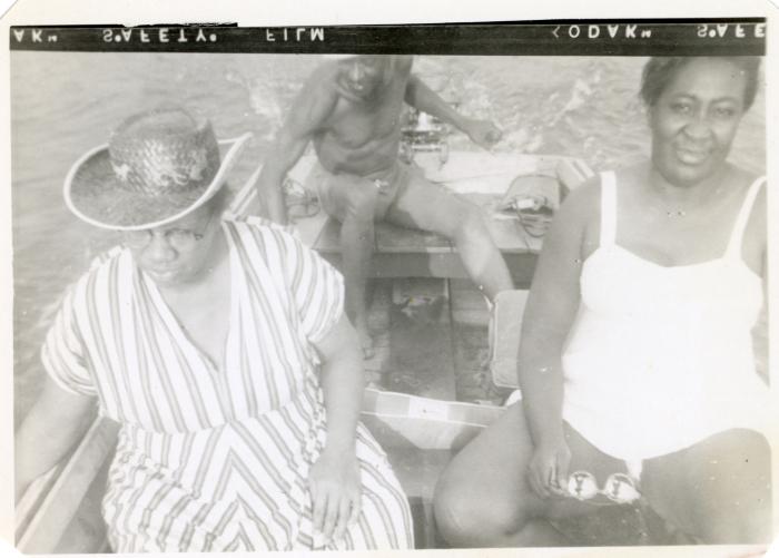 Two women and a man in a boat
