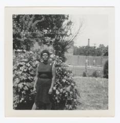 Pearl Cann standing in front of a bush