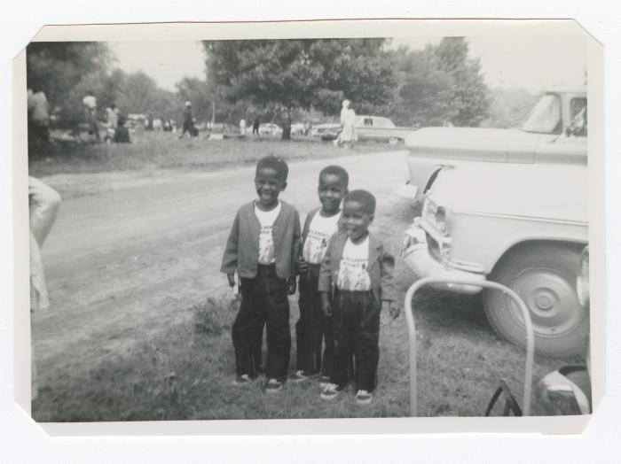 Three young boys in matching outfits