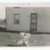 Kenneth Sparks Jr. in a lawn chair in front of family home