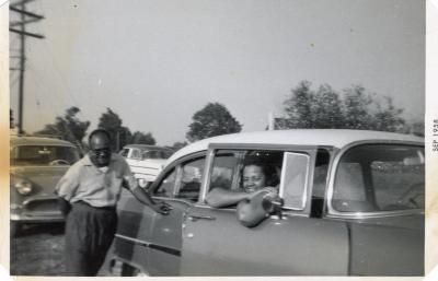 Man and woman hanging out in an automobile