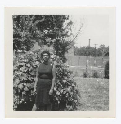 Pearl Cann standing in front of a bush