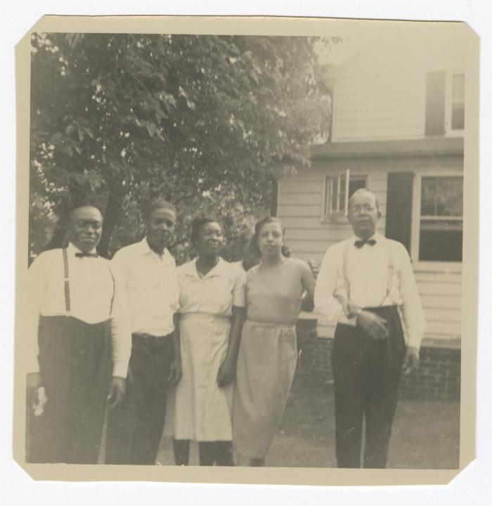 Five adults standing outside